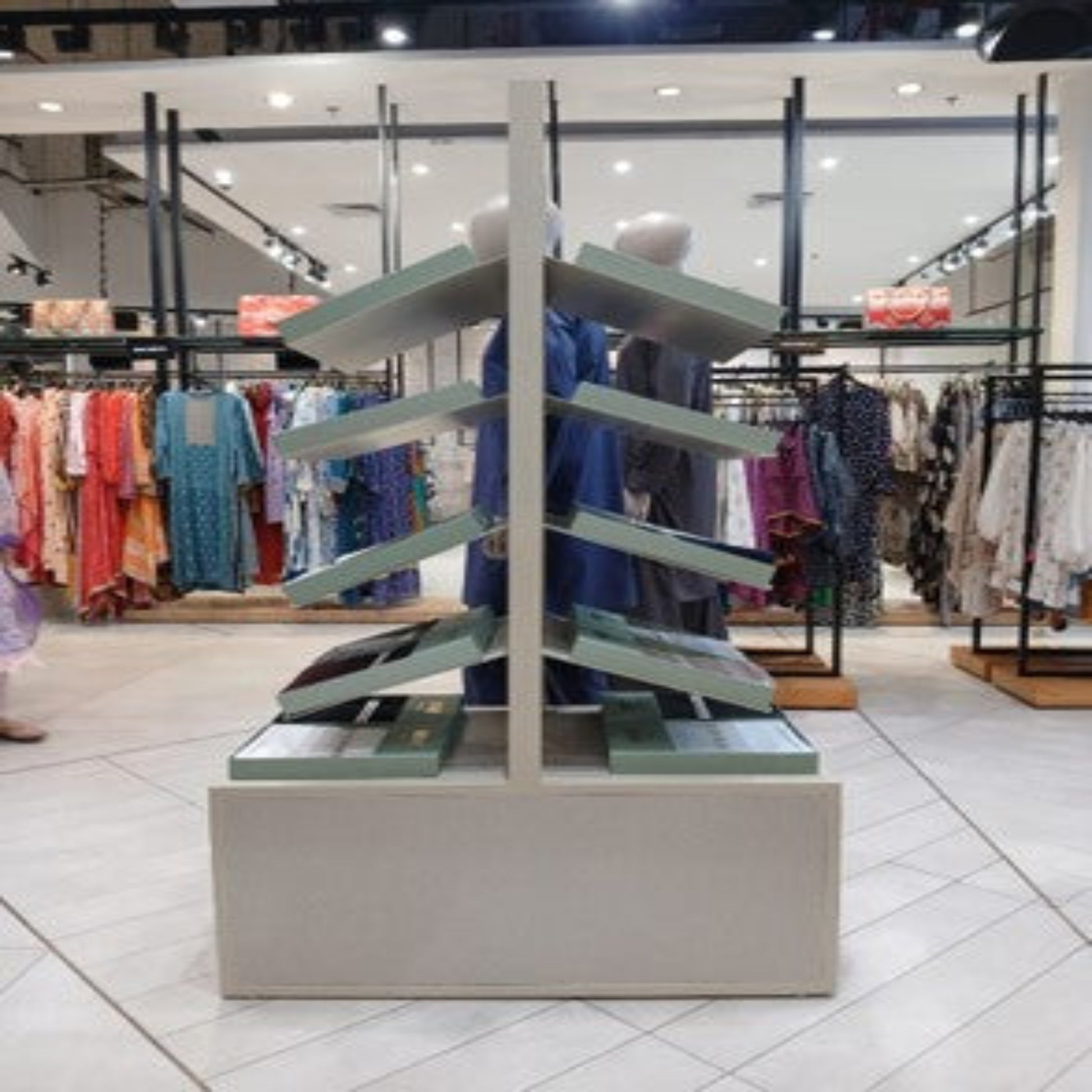 Display stand with clothes in a store setting