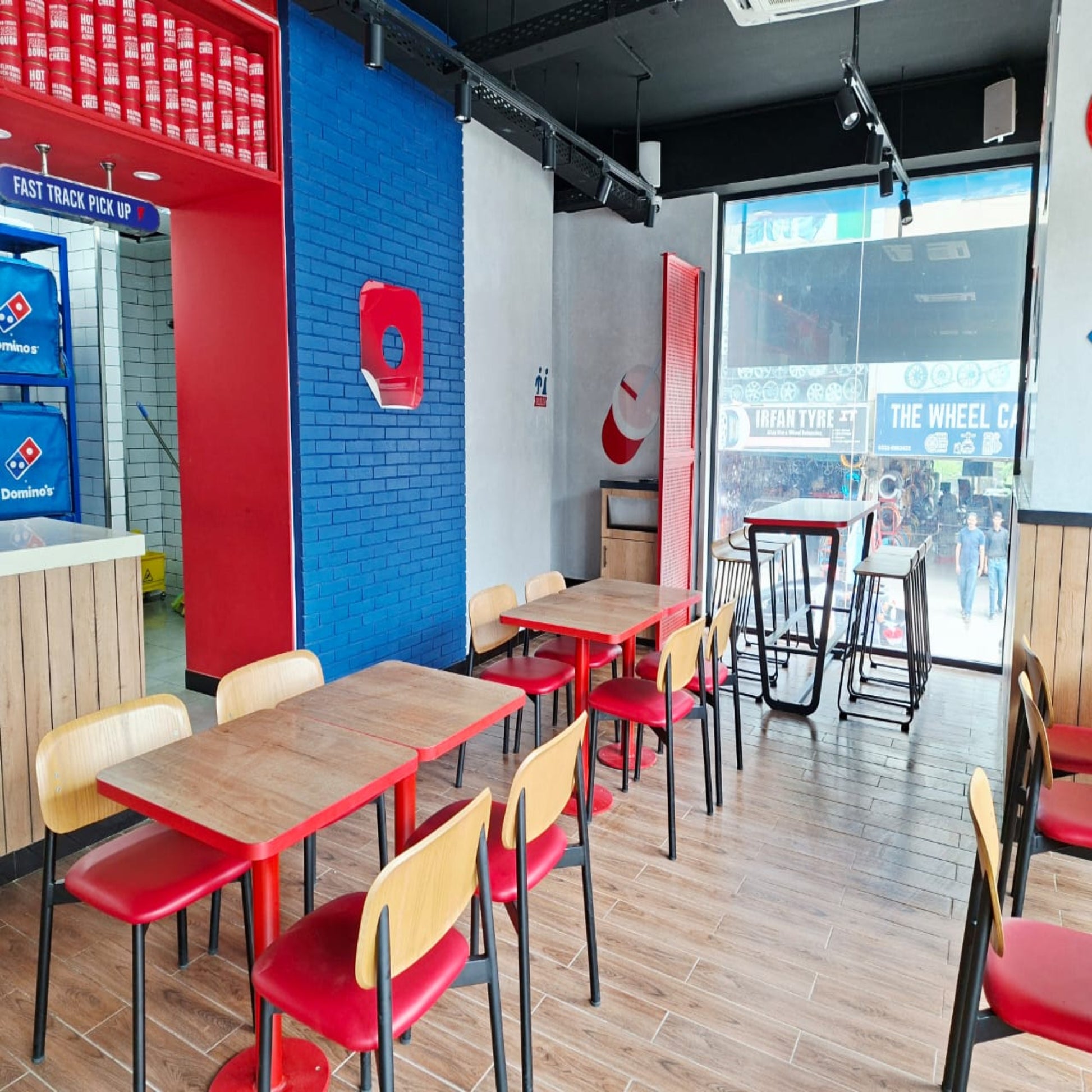Restaurant interior with tables, chairs, and Domino's Pizza branding.
