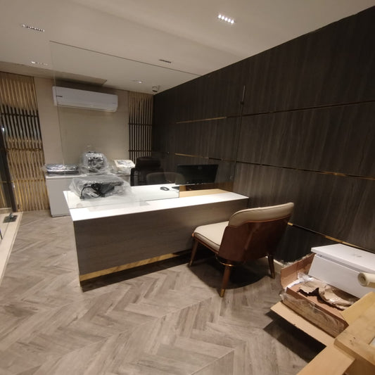 Modern interior with a reception desk and chair in a well-lit room.